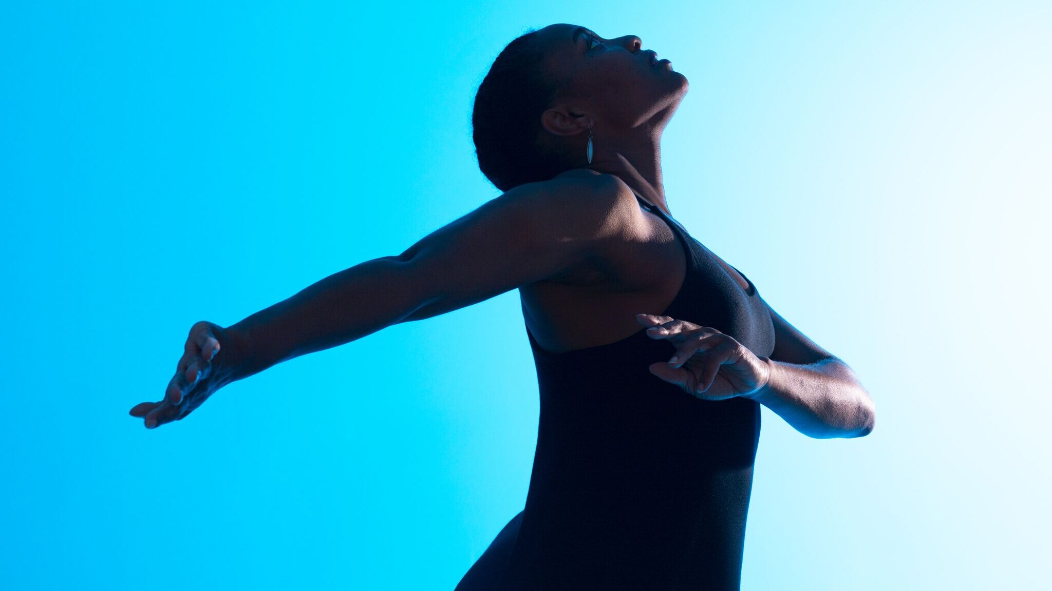 Brownbody Founder and Artistic Director Deneane Richburg performing with outstretched arms