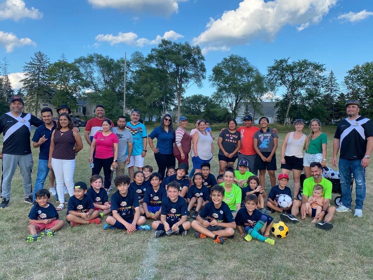 Youth, parents and staff at Esperanza United summer camp soccer game