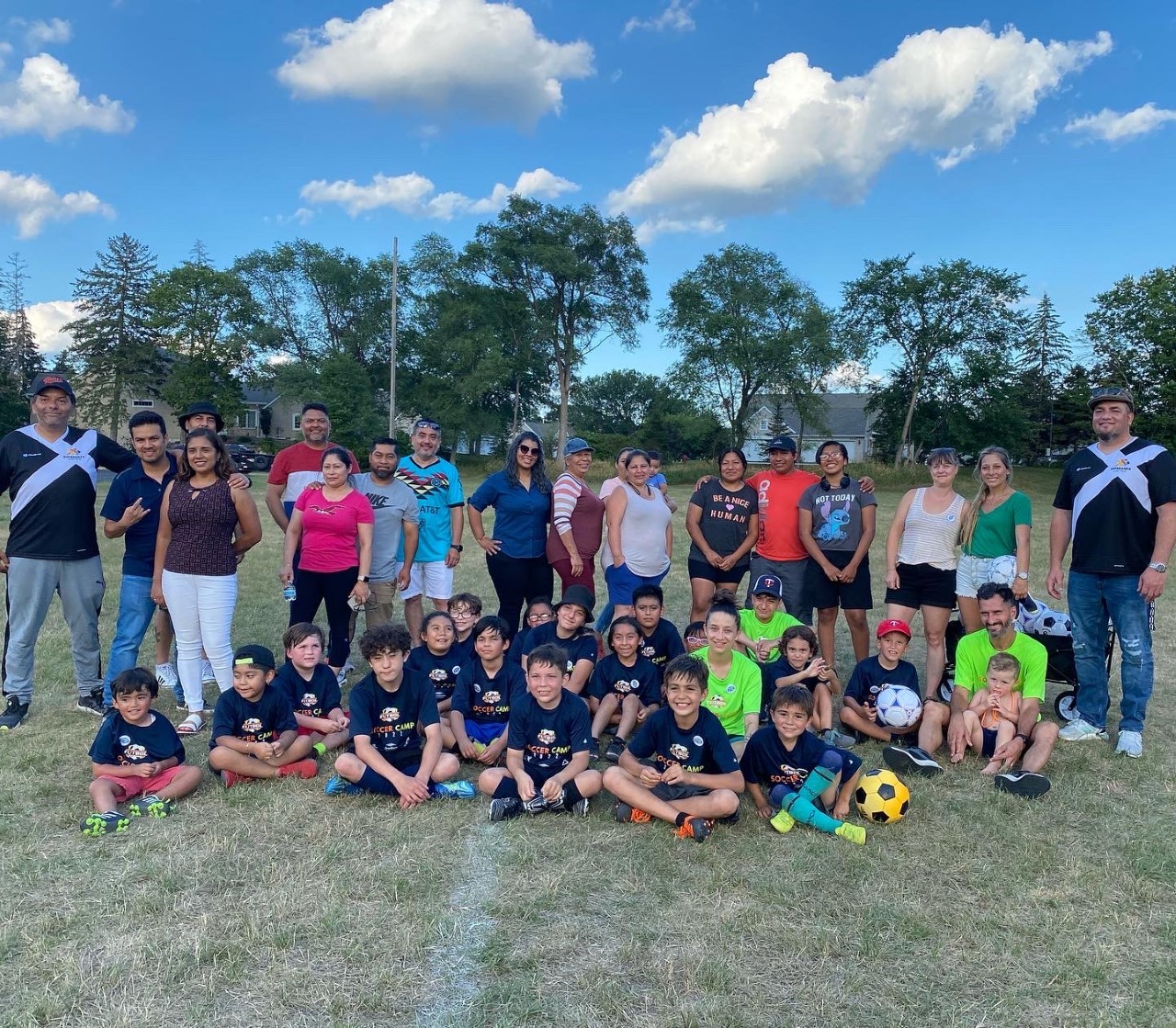 Youth, parents and staff at Esperanza United summer camp soccer game