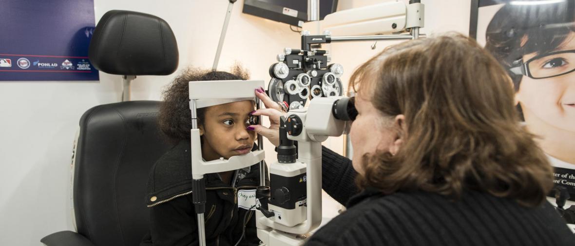 An African American girl gets an eye exam
