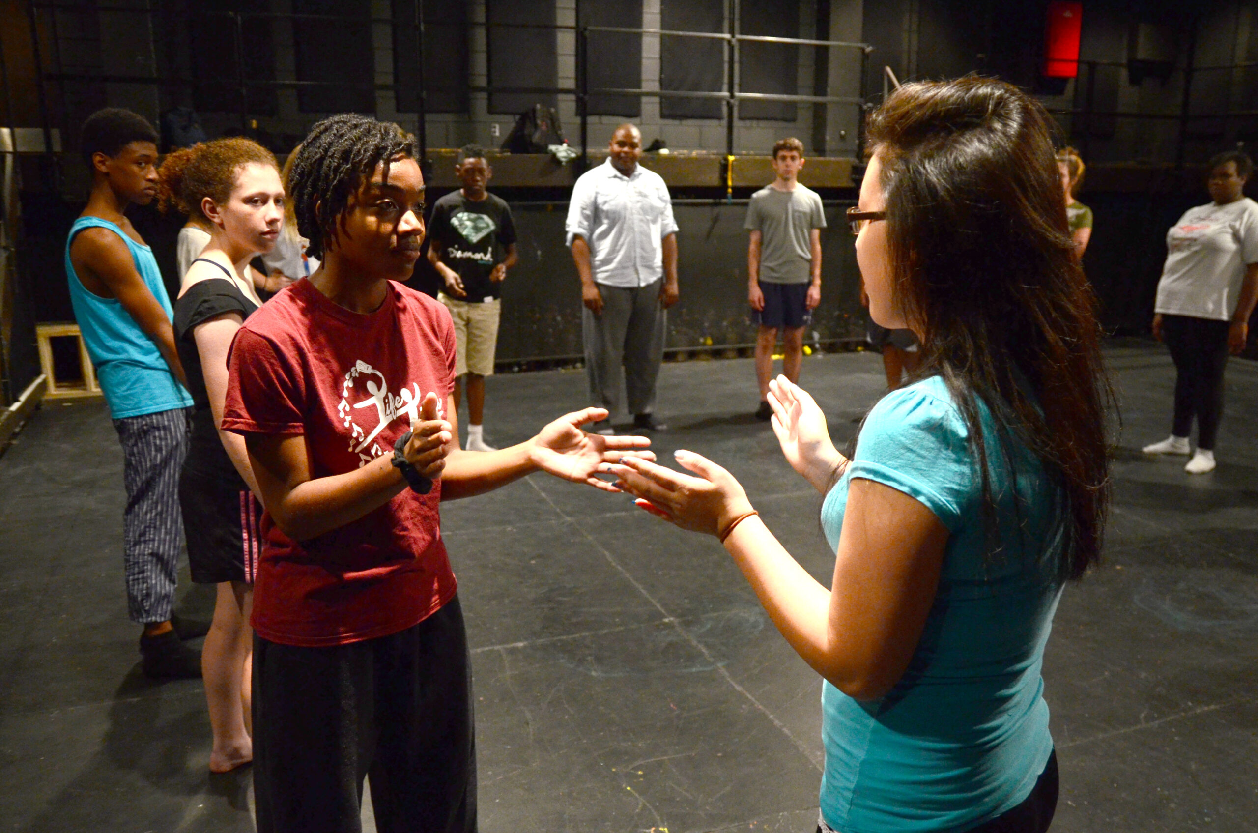 Young people gather in circle and interact with each other