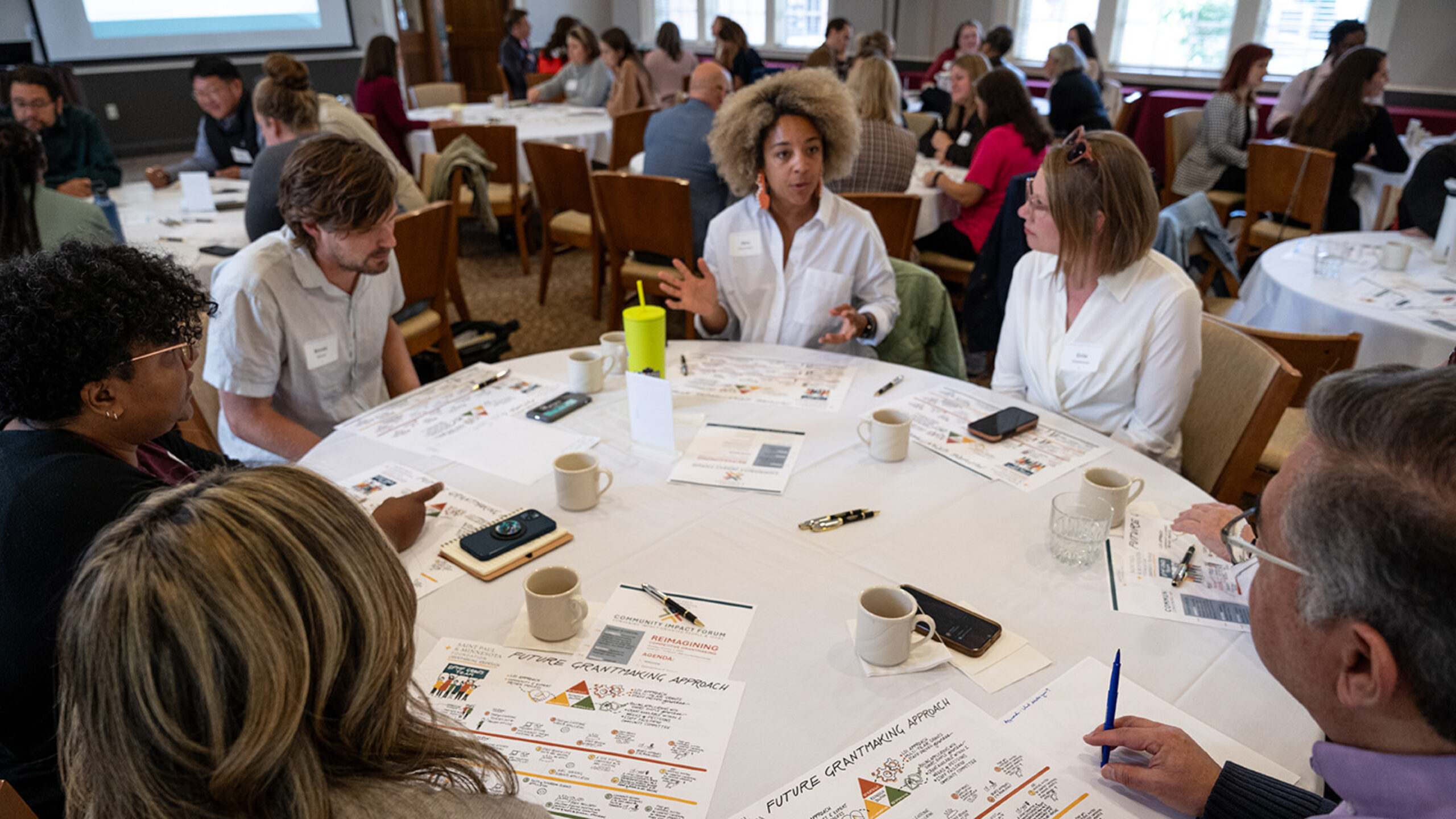 Board member and others sitting at a round table